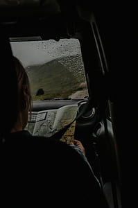 person holding map inside car thumbnail