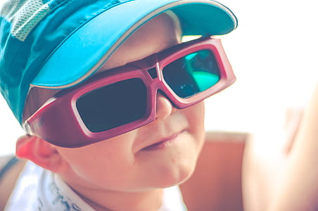 boy wearing black sunglasses with red frames thumbnail