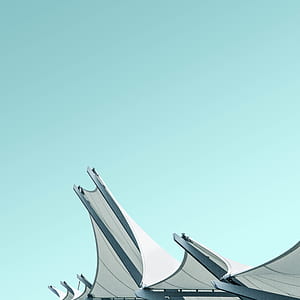 photo of white concrete building under clear blue sky thumbnail