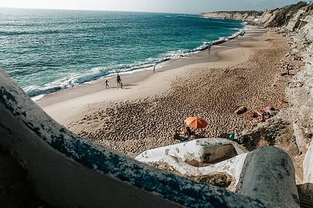 people on seashore near sea at daytime thumbnail