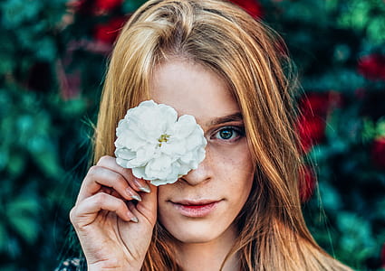photo of woman wearing white petaled flower thumbnail