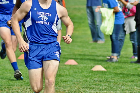 man wearing blue jersey running on green field thumbnail