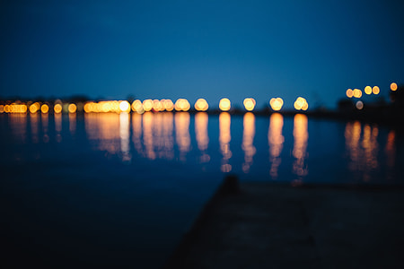 City lights reflected in the water at night thumbnail