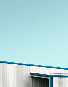 clear blue sky above white and blue steel structure thumbnail