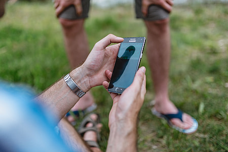 Closeup of man hands playing videogames on cell phone thumbnail