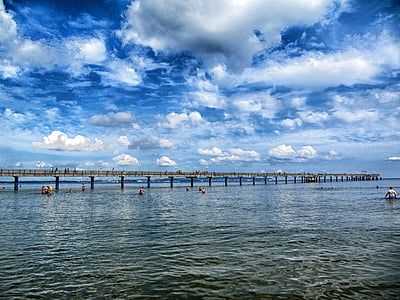 people in body of water near wooden dock thumbnail