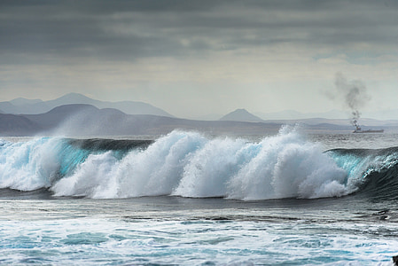 waves of body of water under gray clouds thumbnail