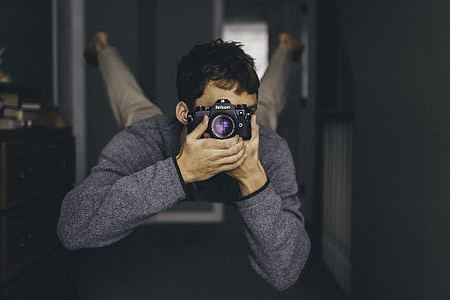man holding camera taking photo while floating thumbnail