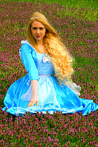 woman wearing white and blue dress while on the purple and green plant grass thumbnail