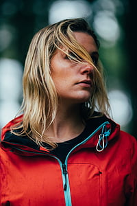 woman wearing red zip-up jacket selective focus photography thumbnail