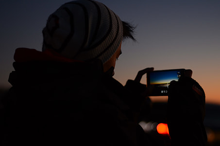person taking photo wearing hat during nighttime thumbnail