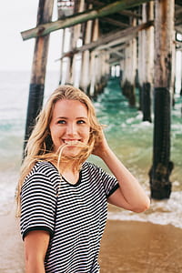 focus photography of woman wearing white and black striped ringer shirt thumbnail