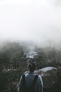 woman standing in front of foggy trees thumbnail