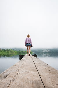 woman walking on beach dock thumbnail