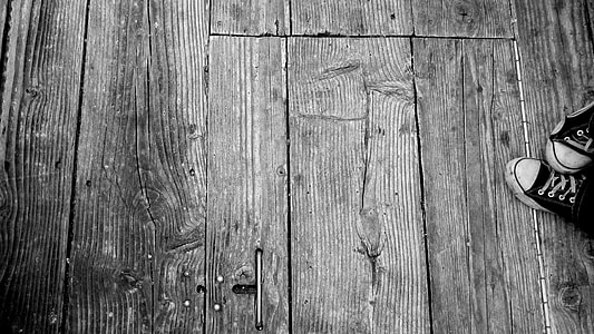 gray scale photo of pair of converse all star chuck taylor on top of brown wooden pallet thumbnail
