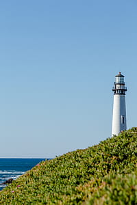 white lighthouse near sea thumbnail