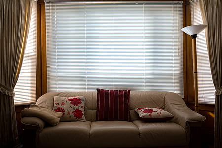 brown leather 3-seat sofa near windows thumbnail