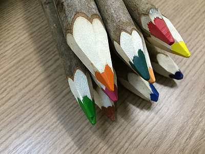 assorted-color sharpened coloring pencils on brown surface thumbnail