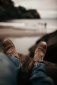 person wearing brown leather boots thumbnail