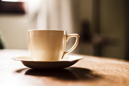 White Ceramic Teacup With Saucer on Wooden Table thumbnail