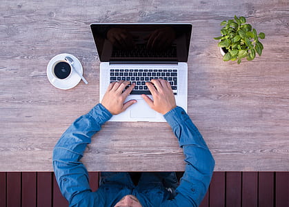 person's two hands on MacBook Pro thumbnail