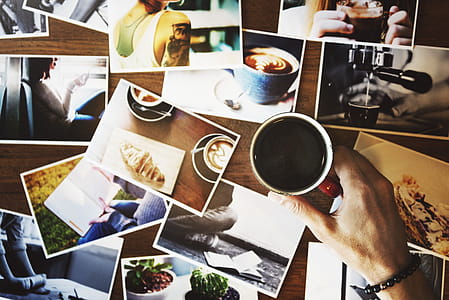 Person Holding Mug Beside Photos thumbnail