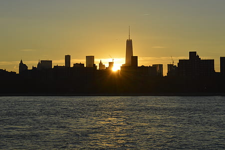 silhouette of building in front of body of water thumbnail