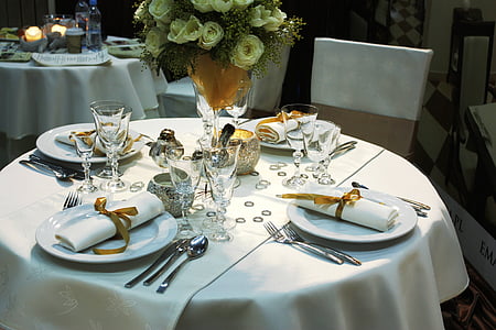 plates, utensils, and napkins on table thumbnail
