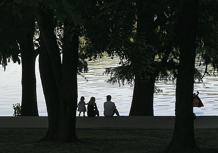 people sitting in front of body of water thumbnail