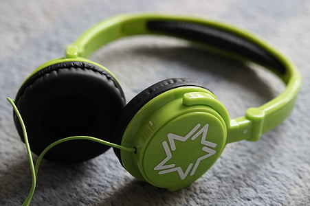 selective focus photography of green and black corded headphones thumbnail