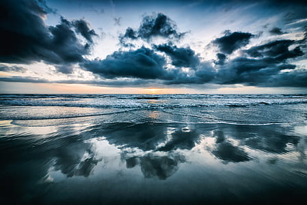 reflection of cloudy sky during day time thumbnail