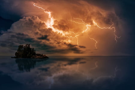 photo of island between body of water with lightning storm thumbnail