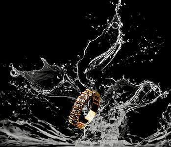 gold-colored ring beside body of water thumbnail