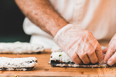 man wearing gloves making sushi thumbnail