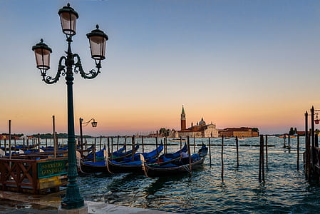 Green Metal Post in Front of the Body of Ocean With Boats during Twilight thumbnail