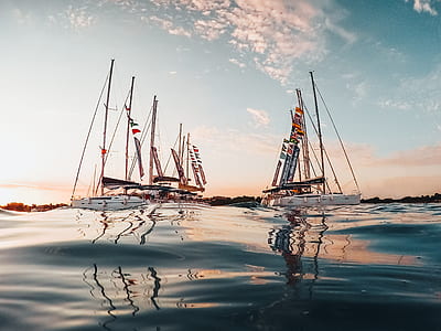 sail boat under white clouds during daytime thumbnail