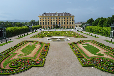 yellow and gray building in front of garden thumbnail