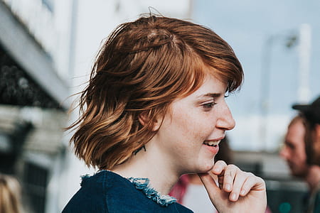 shallow focus photography of woman holding her chin thumbnail