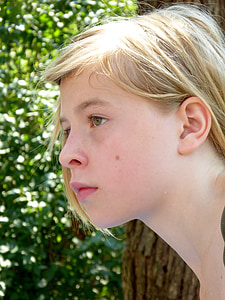 girl's face near brown tree thumbnail