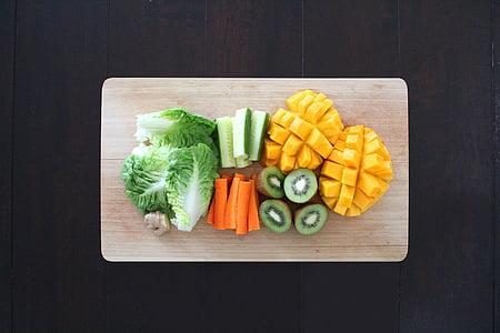 flat lay photography of sliced fruits and vegetables on chopping board thumbnail