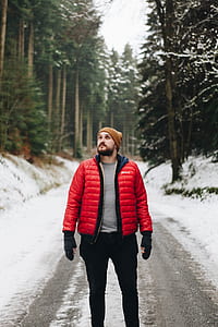 shallow focus photography of man standing on road while looking upward thumbnail