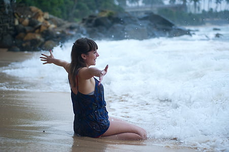 time-lapse photography of woman sitting on seashore thumbnail
