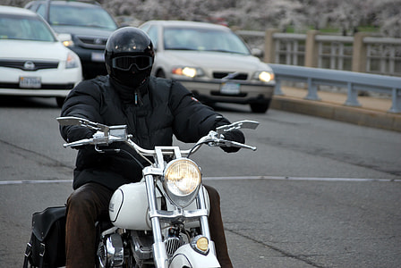 man riding on cruiser motorcycle on the street thumbnail