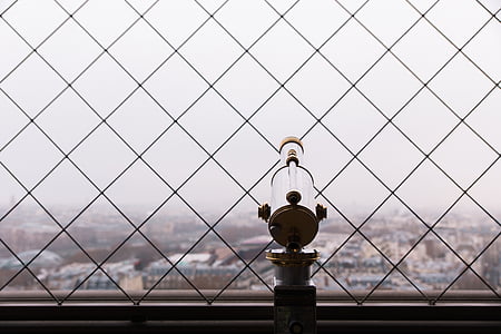 gray and brown telescope besides chain link fence at daytime thumbnail