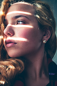 blond haired woman in red and black coat thumbnail