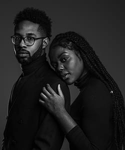 grayscale photo of man wearing suit jacket and turtleneck shirt and woman wearing turtleneck long-sleeve shirt thumbnail