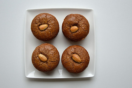 four chocolate cookies on white ceramic plate thumbnail
