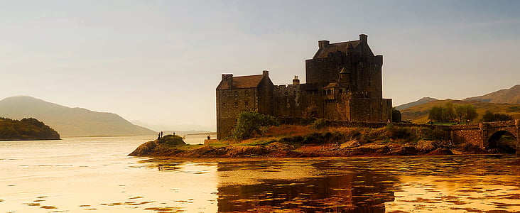 brown concrete house near body of water thumbnail