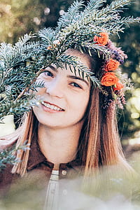 smiling woman with flowers in hair headdress thumbnail