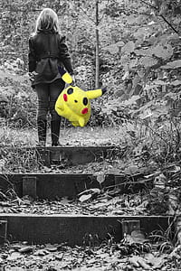 woman carrying pikachu plush toy thumbnail